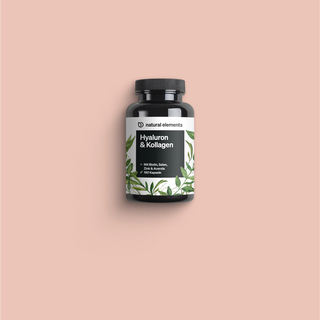 Una bottiglia di Vitamina C con foglie verdi su sfondo rosa, che mette in risalto gli elementi naturali.
