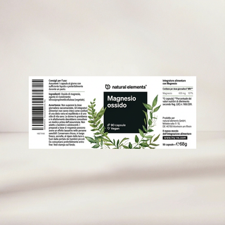 Vegane Kapseln "Magnesio ossido" von Natural Elements, mit Abbildungen von grünen Blättern und Text auf Italienisch und Französisch.