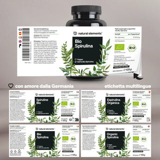 Un flacone e una confezione di compresse di Natural Elements Bio Spirulina con etichette multilingue in tedesco, italiano, spagnolo e inglese, che evidenziano la certificazione vegana e biologica.
